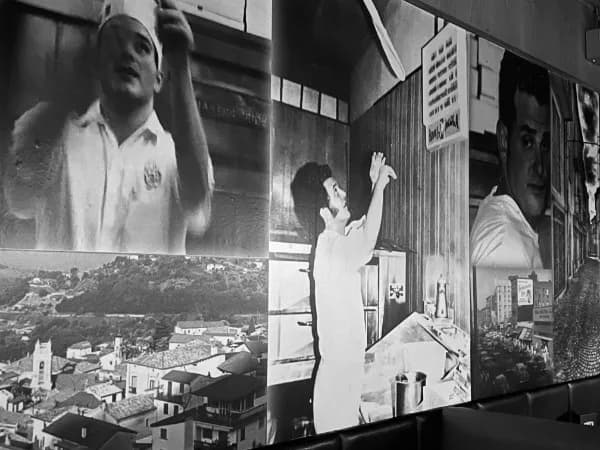 The memory wall of old black-and-white photographs at Tony's