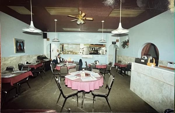 Inside the dining room in the early years, tables set with linens