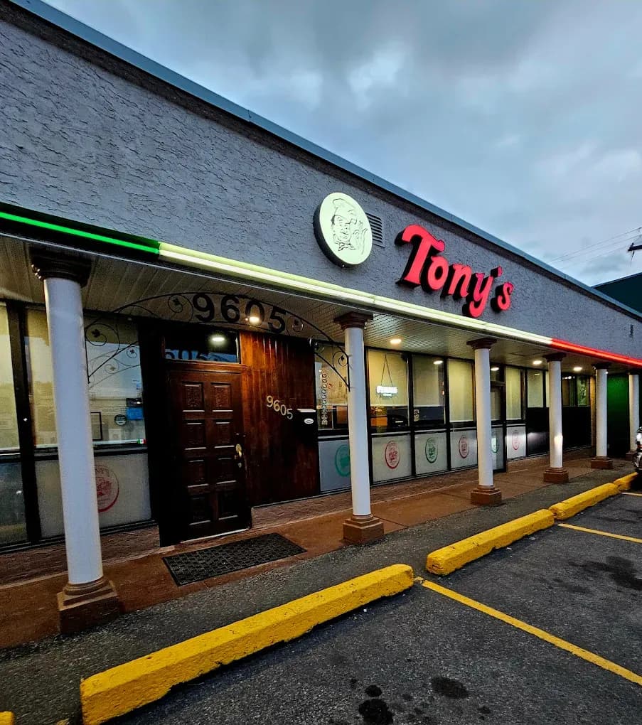 The exterior of Tony's Pizza Palace with its street signage