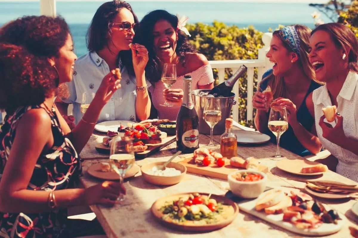 Friends sharing wine and antipasti at the table